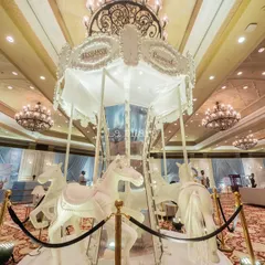 A magnificent, life-sized white carousel as the centerpiece of a royal-themed event at the Taj Palace. This stunning installation adds a touch of whimsical elegance and serves as an incredible photo opportunity for guests.