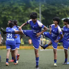 Flexibility and injury prevention are key. Our girls' team performs dynamic stretches as part of their warm-up routine before a competitive training session.
