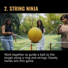 This is String Ninja, where steady hands win the game. Your team has to work together to guide a ball to its target using a ring and strings.