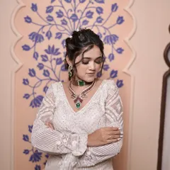 This model showcases an elegant updo with soft, face-framing tendrils. It's a versatile look that works well for any formal event.
