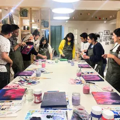 A team gathers around their abstract paintings, discussing techniques and admiring each other's work. It's a great way to see a different, more creative side of your colleagues.