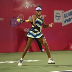 Hitting a forehand on the run during my match against the top seed in Mumbai. This win was a battle, and every point required aggressive play and strong footwork.