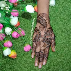 Just a girl who loves mehendi. This bold, leafy design covers the back of the hand in a beautiful, flowing pattern.