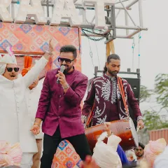 Sharing a moment with the groom's father during the baraat. It's a celebration for the entire family, and I make sure everyone feels the excitement.