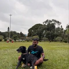 Sitting on the grass with Batman in Cubbon Park. He's more than a pet; he's family.