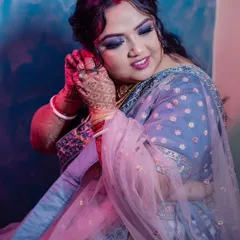 A beautiful, artistic shot of my bride getting ready for her reception. The blue and pink lighting highlights her dramatic eye makeup.