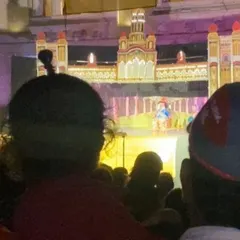 The vibrant lights of the stage illuminate the night, creating a magical atmosphere for the audience.