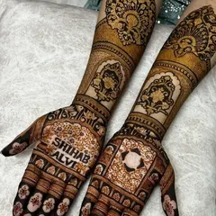 A beautiful example of incorporating names directly into the mehndi design. This style is perfect for engagement or anniversary celebrations.
