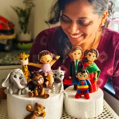 The moment a student truly sees what they're capable of creating. Here she is, admiring the collection of detailed fondant characters she sculpted herself during our masterclass.