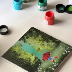 A flat-lay of my rainy day painting. The little figure with the red umbrella adds a touch of playful nostalgia to the otherwise serene forest scene.