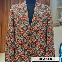Show off your personality with this uniquely printed designer blazer. The intricate, colorful pattern makes it a standout piece for any celebration. It's available on clearance for just ₹2500, a small price for big style.