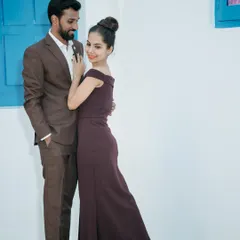 A stylish couple's portrait against a clean, modern backdrop. This highlights our versatility in creating both traditional and contemporary pre-wedding photos.