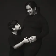 A beautiful black and white image of a mother and her son sharing a quiet moment before the new baby arrives. This portrait captures the special bond they share.
