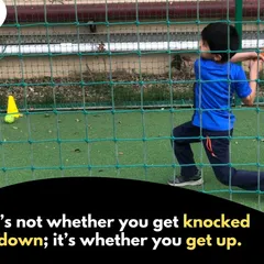 Every champion starts with the first step. This young player is practicing his swing in the nets, a core part of our training where we provide a safe and focused environment to hone batting skills.