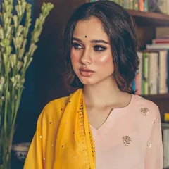 For this ethnic wear shoot, we designed a look with a dramatic winged eyeliner and luminous skin. The soft, textured waves in the hair add a modern touch to the traditional aesthetic.