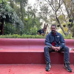 A relaxed weekend at a farm stay in Kamshet. Here I am enjoying the peaceful surroundings while our dog Jiraiya explores the green space behind me.