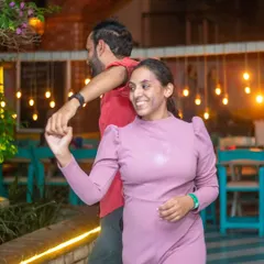 A beautiful smile, even with a splash of purple Holi color. Our themed nights bring out the playful side in everyone.