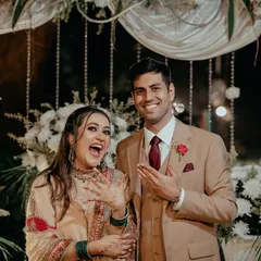 The couple proudly shows off their new rings after their intimate engagement ceremony, their faces beaming with happiness.