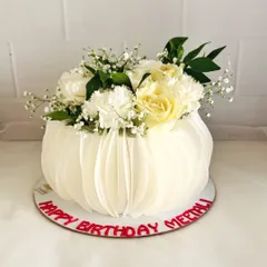 A still shot of the beautiful wafer paper and floral cake, a perfect centerpiece for an elegant birthday.