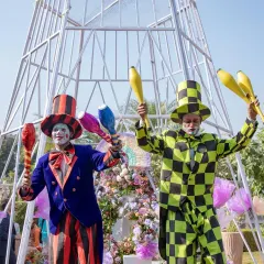 I believe in keeping the fun alive with engaging entertainment. Here, carnival performers and jugglers welcome guests to a festive daytime event.