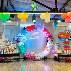 A high-energy Cars and Unicorns theme for a joint birthday bash. We can combine different themes to make sure every birthday star feels special, complete with custom decor and a 'Happy Birthday' neon sign.