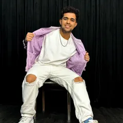 A seated pose from my purple jacket photoshoot. I believe confidence is key, whether you're on stage or in front of a camera.