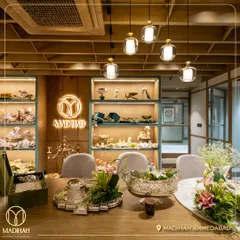 A view of the consultation table at our Ahmedabad store. The space is designed to be warm and inviting, allowing clients to explore our collections and create their perfect gift in a luxurious setting.