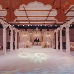 A wide view of the palatial stage we constructed, complete with a pristine white dance floor. The design was centered around tall, standing arches to enclose the space and create the feel of a royal courtyard.