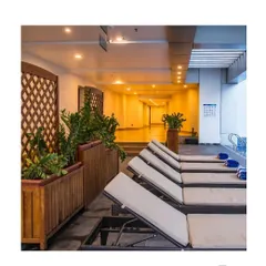 The poolside lounge area of a luxury hotel project in Calicut. This space demonstrates how I extend the landscape experience indoors, using large planters with lush greenery and natural wood trellises to create a tranquil, resort-like atmosphere.