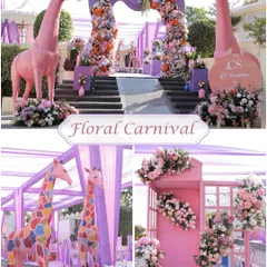 A Floral Carnival theme for a Haldi ceremony, featuring whimsical pink giraffes and lush floral arches to create a fun and fantastical atmosphere.