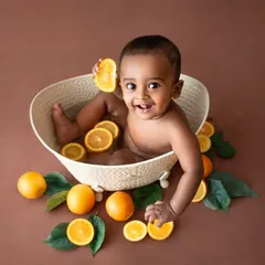 Playing with the oranges! These sessions are very interactive and perfect for babies who can sit up confidently.