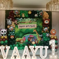 Go wild with a full jungle safari theme for a first birthday. This large-scale decoration features a dense jungle backdrop, marquee letters, and cutouts of a panda, tiger, lion, and more.