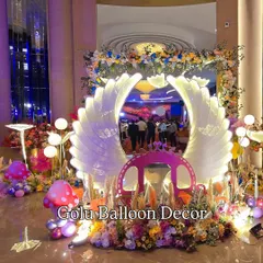 For a magical welcome party, I designed this enchanted butterfly theme. The large, backlit angel wings create a stunning focal point, complemented by a princess carriage, mushroom props, and a mix of floral and balloon decorations.
