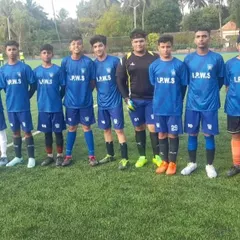The starting lineup for a tournament match in Goa. The players look focused and ready to represent the academy.