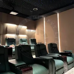 In this Amritsar home theater, we combined luxurious green recliners with textured 3D wall panels and soft backlighting. The fiber optic star ceiling adds a touch of magic, creating a private celestial escape for watching films.