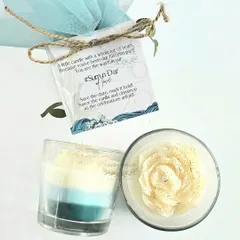 Gifts that Tell a Story. A close-up of a Save-The-Date gift created for a couple's ocean-themed wedding. This layered votive candle, with its custom tag and beautiful packaging, shows how every detail is tailored to bring your vision to life.