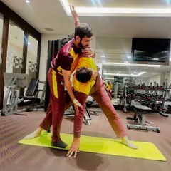 Guiding an athlete through Trikonasana (Triangle Pose). This pose is excellent for opening the hips and stretching the hamstrings and spine, improving overall agility on the field.