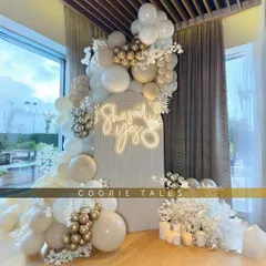 A breathtaking moment for a beautiful promise. We designed this elegant 'She Said Yes' engagement party setup with a clean, all-white theme, accented with gold balloons, soft lighting, and a custom neon sign to celebrate the special occasion.