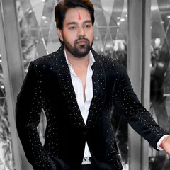 A client looking dapper in a black velvet blazer with scattered silver embellishments. This design is a favorite for its balance of classic style and modern flair.