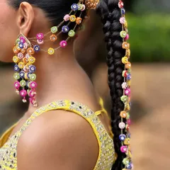 Hair is an art form. For Aish's Haldi, we created this stunning long braid, weaving in vibrant, handcrafted floral accessories that perfectly matched the joy and color of the ceremony. This hairstyle is designed to be both beautiful and comfortable.