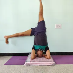 Here I am demonstrating a variation of Shirshasana (Headstand), using the wall for balance and alignment. This is Parsvaika Pada Shirshasana. The wall is a tool, a teacher. It provides feedback so you can understand the correct extension and rotation in the pose without fear of falling.