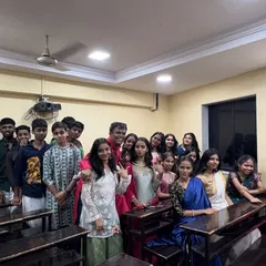 Prof. Parab with a group of students during the Satyanarayan Pooja. These informal interactions help build strong, supportive relationships between teachers and students.