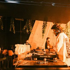 A candid shot from a set at Shimmers. The orange lighting and hanging plants created a cool, jungle-like vibe.