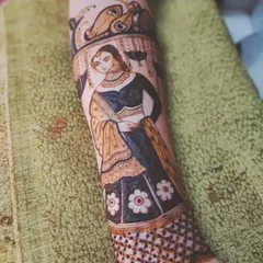 A finished bridal figure on an arm, showcasing a full-length portrait with detailed clothing and jewelry. This is the kind of advanced work my course prepares you for.