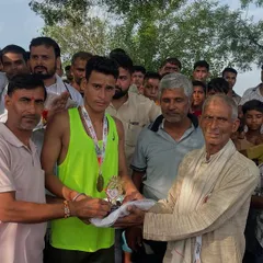 A young winner receiving his trophy and prize. It is my 'dharm' to encourage these young 'cheete' and give them a platform to prove their 'mehnat'.