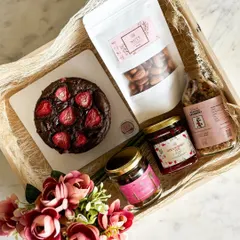 We offer fully customizable vegan hampers. This beautiful gift includes our vegan strawberry chocolate cake, almond cranberry granola, homemade strawberry jam, and other plant-based treats.