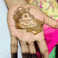 A simple yet meaningful design for a groom, featuring the couple's names, Vaishnavi and Prasad, inside an ornate frame. It's a sweet and personal touch.