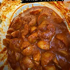 A close-up of my tangy and spicy Amla pickle, also known as nellikai uppinakayi. Each piece of Indian gooseberry is coated in a rich, hand-ground masala, offering a perfect balance of flavours.