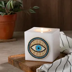 A square version of my evil eye tea light holder. The beaded design is set against a solid block of white wax for a modern, stylish look.