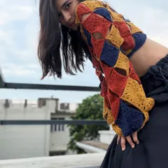 The open-shoulder detail and the way the squares connect is what makes this handmade crochet top so special. It's a design that is both airy and statement-making.